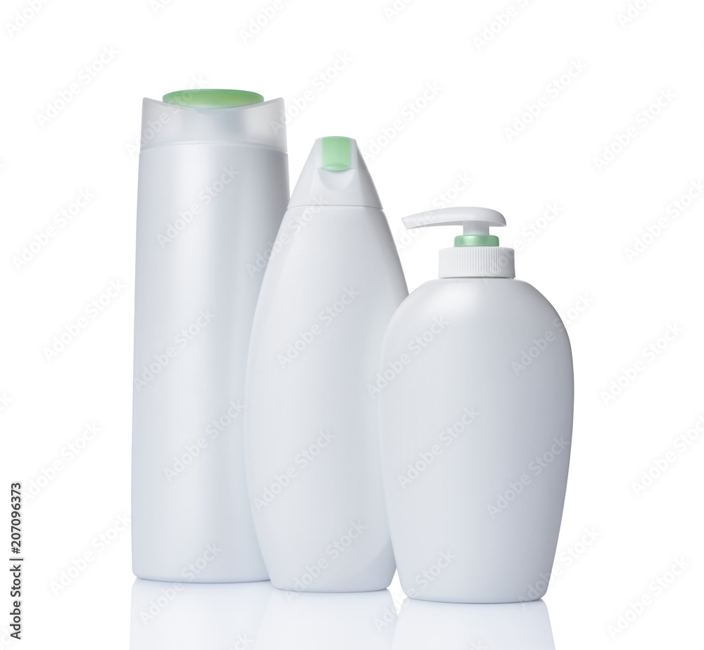 Blank white mockup dispenser and plastic bottles of cosmetic products with green lids Blank white mockup dispenser and plastic bottles of cosmetic products with green lids