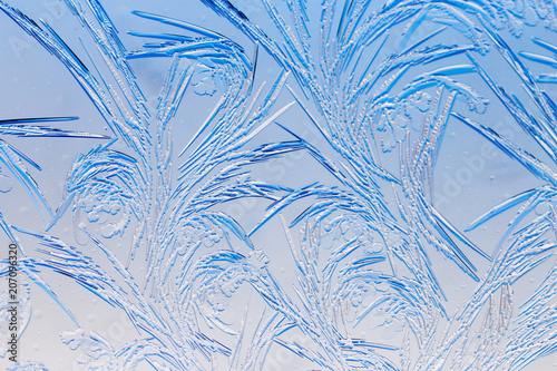 Blue drawings on the glass in the frost