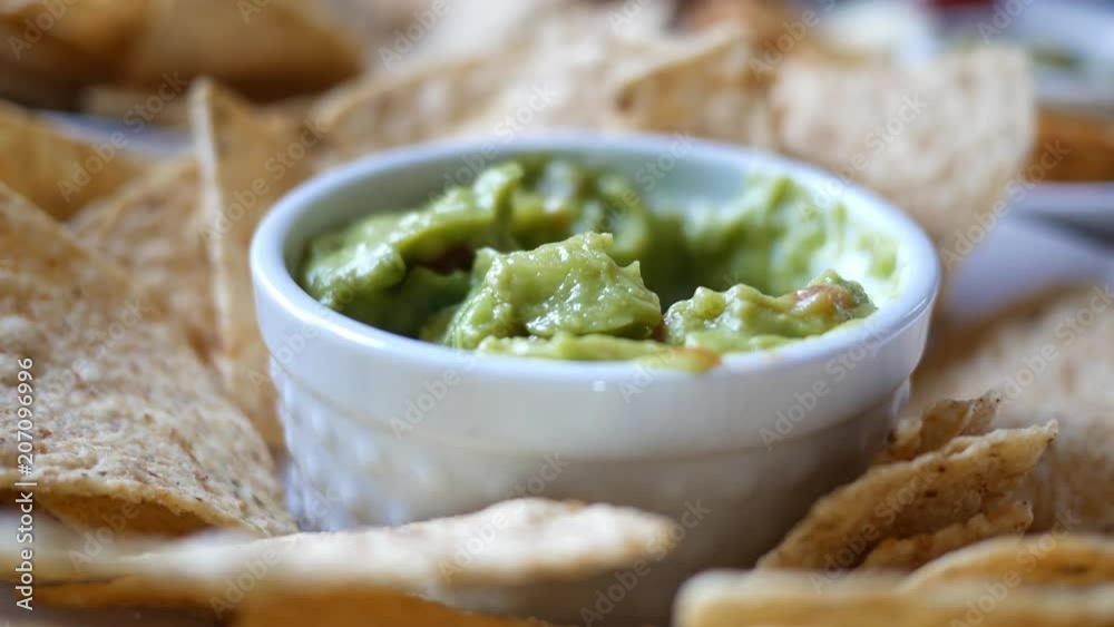Person eating guacamole while scooping a chip - V2 Person eating guacamole while scooping a chip - V2
