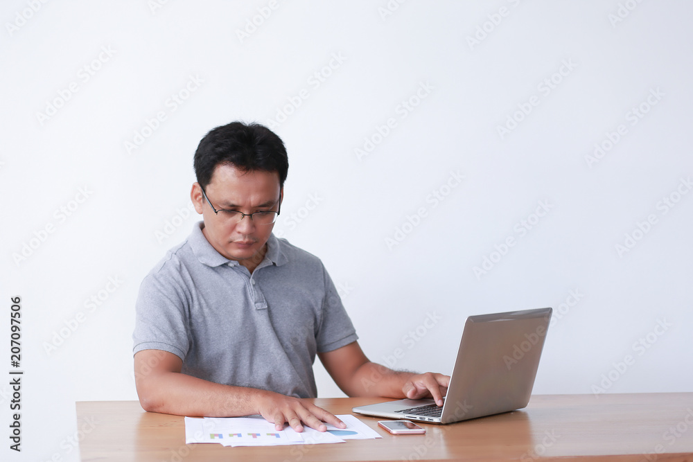 Handsome businessman is working with laptop in office Online