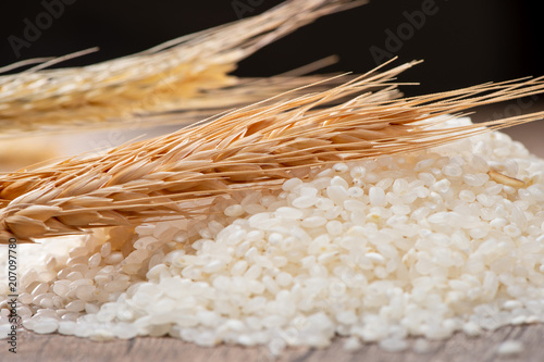 raw rice and wheat on wooden background