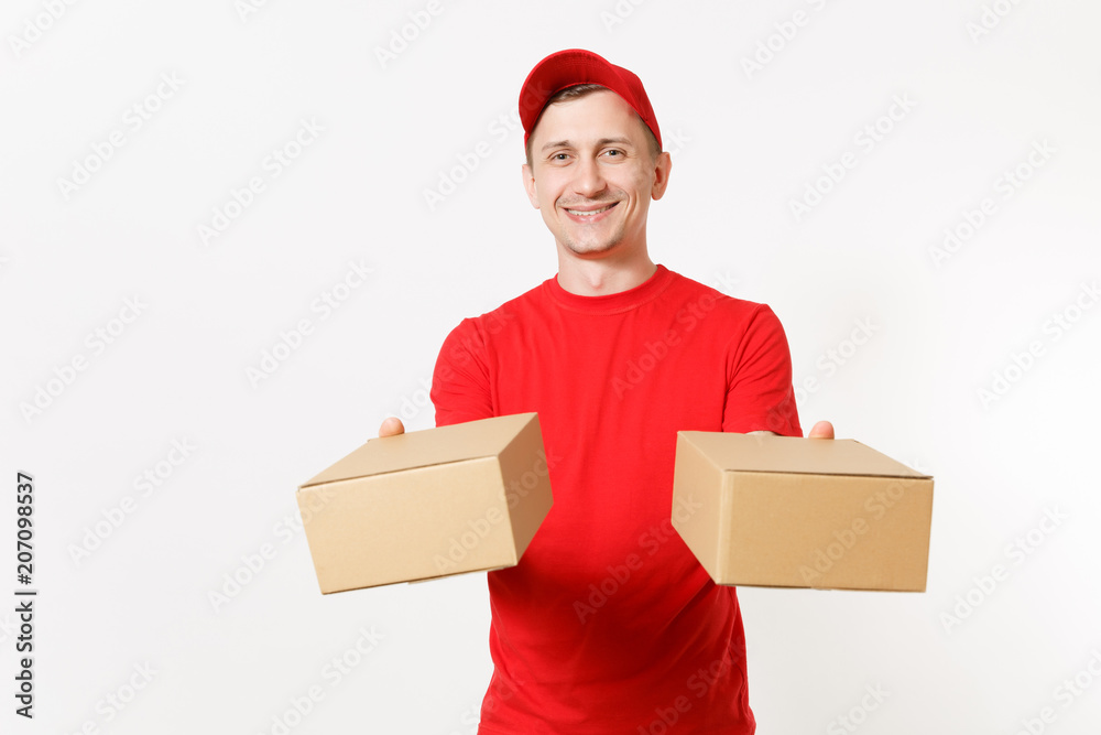 Delivery young man in red uniform isolated on white background. Male in cap, t-shirt working as courier or dealer holding two empty cardboard boxes. Receiving package. Copy space for advertisement. Delivery young man in red uniform isolated on white background. Male in cap, t-shirt working as courier or dealer holding two empty cardboard boxes. Receiving package. Copy space for advertisement.