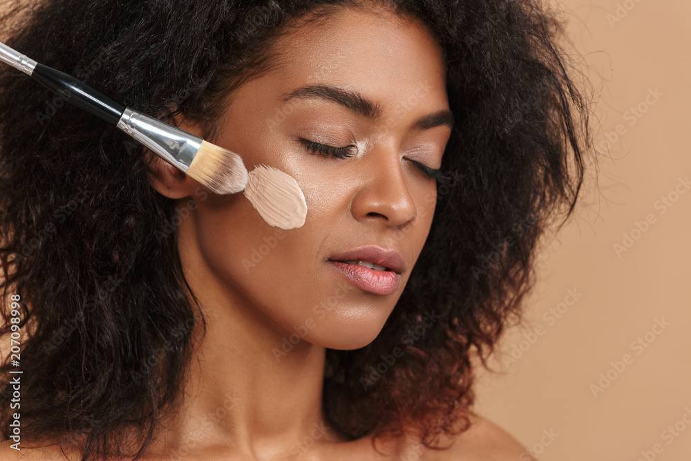 Close up image of Young pretty african woman using brush Close up image of Young pretty african woman using brush
