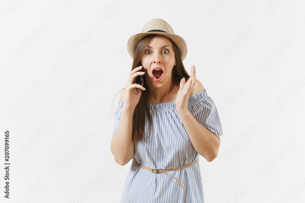 Surrprised upset young woman dressed blue dress, hat has some problems, hears fake news or unexpected rumor in mobile phone isolated on white background. People, sincere emotions, lifestyle concept. Surrprised upset young woman dressed blue dress, hat has some problems, hears fake news or unexpected rumor in mobile phone isolated on white background. People, sincere emotions, lifestyle concept.