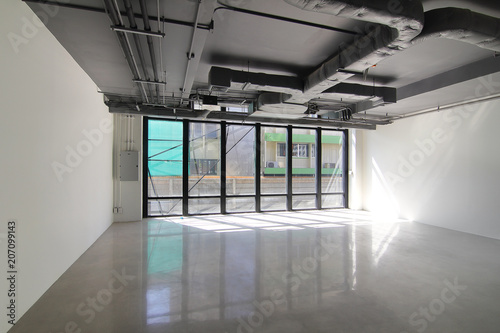 Empty office room on modern building with sunlight and indoor ventilation system on hight ceiling of large building
