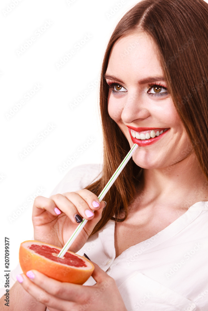 Woman holds grapefruit drinking juice from fruit Woman holds grapefruit drinking juice from fruit