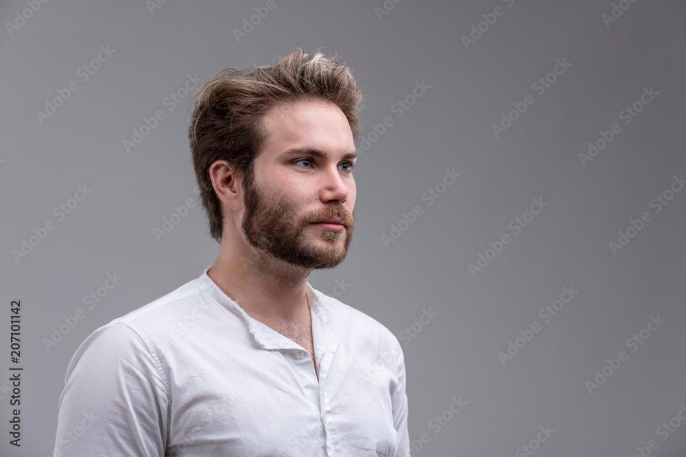 Intense young man staring straight ahead Intense young man staring straight ahead