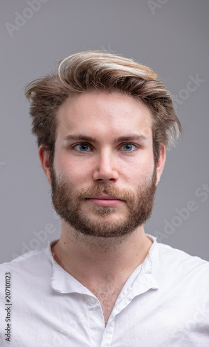 Portrait of a handsome young bearded man thinking
