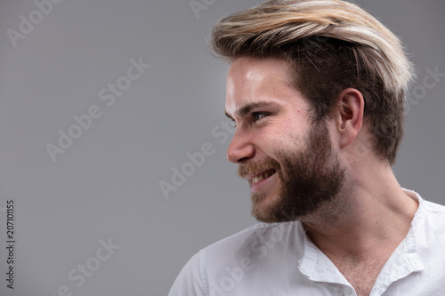 Happy bearded man looking to the side