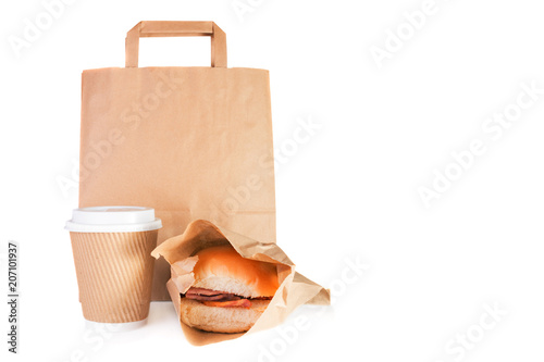 Brown paper carrier bag, take away paper cup, bacon roll in a take away wrap