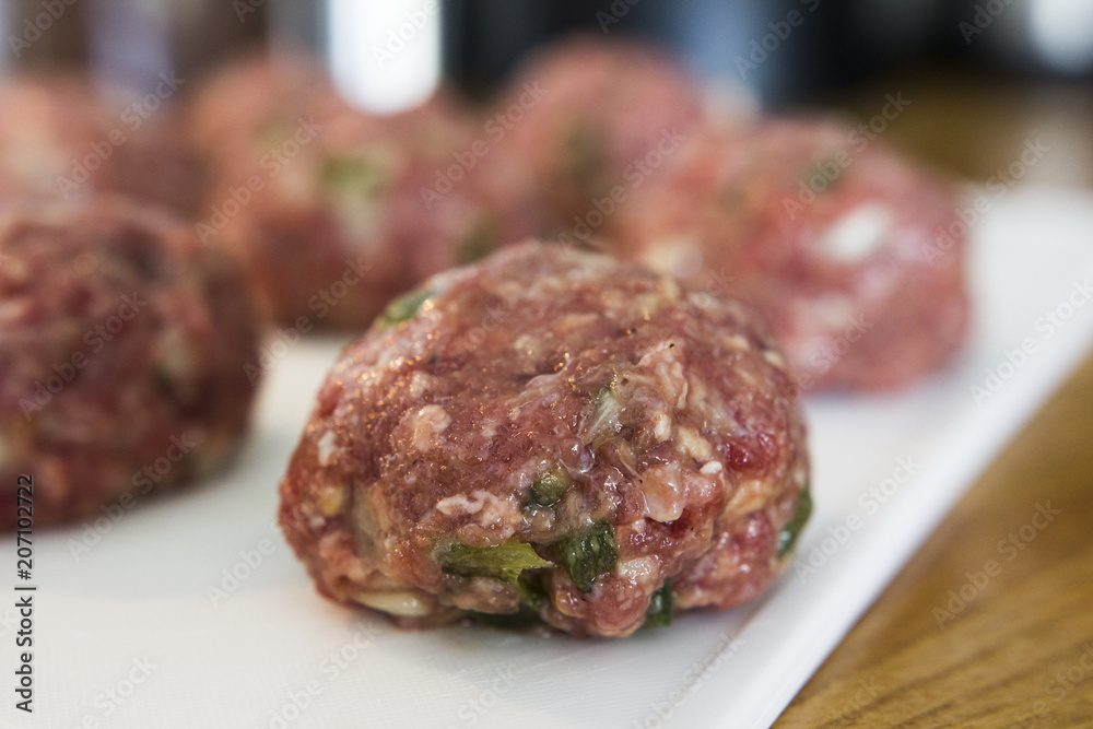 Making meatballs in a kitchen Making meatballs in a kitchen