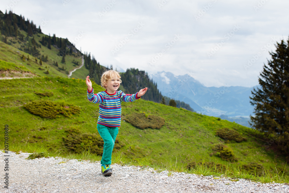 Children hiking in Alps mountains. Kids outdoor.