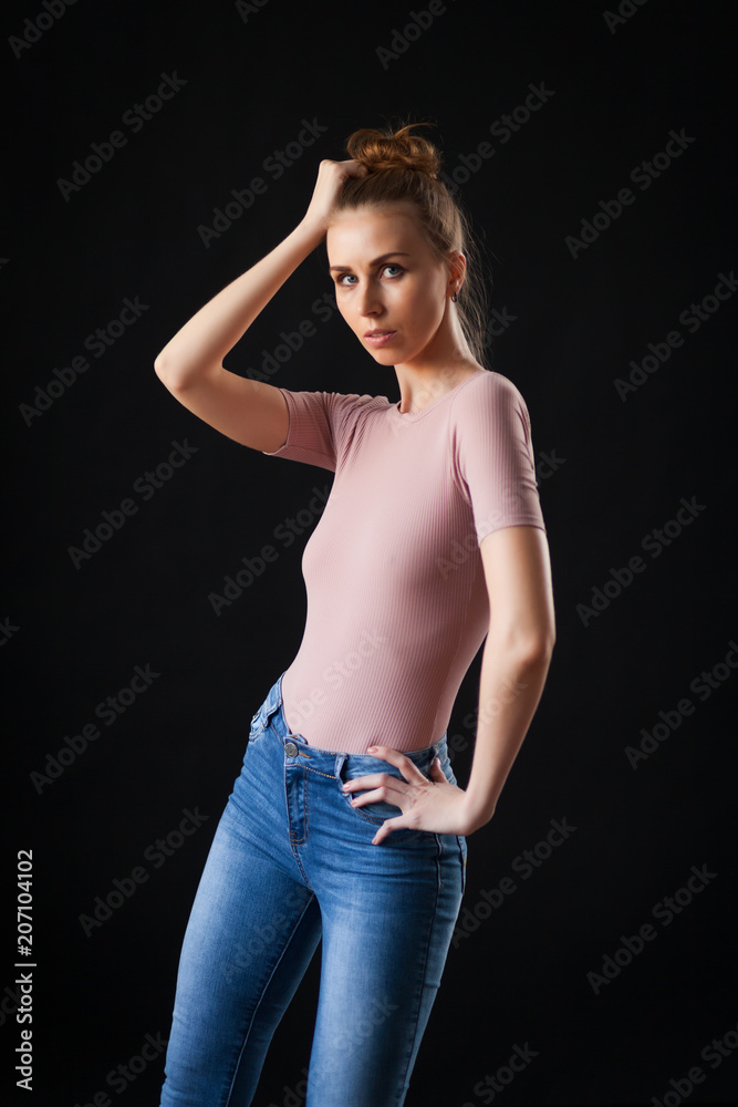 high fashion portrait of young elegant woman in beige top and jeans. Studio shot high fashion portrait of young elegant woman in beige top and jeans. Studio shot
