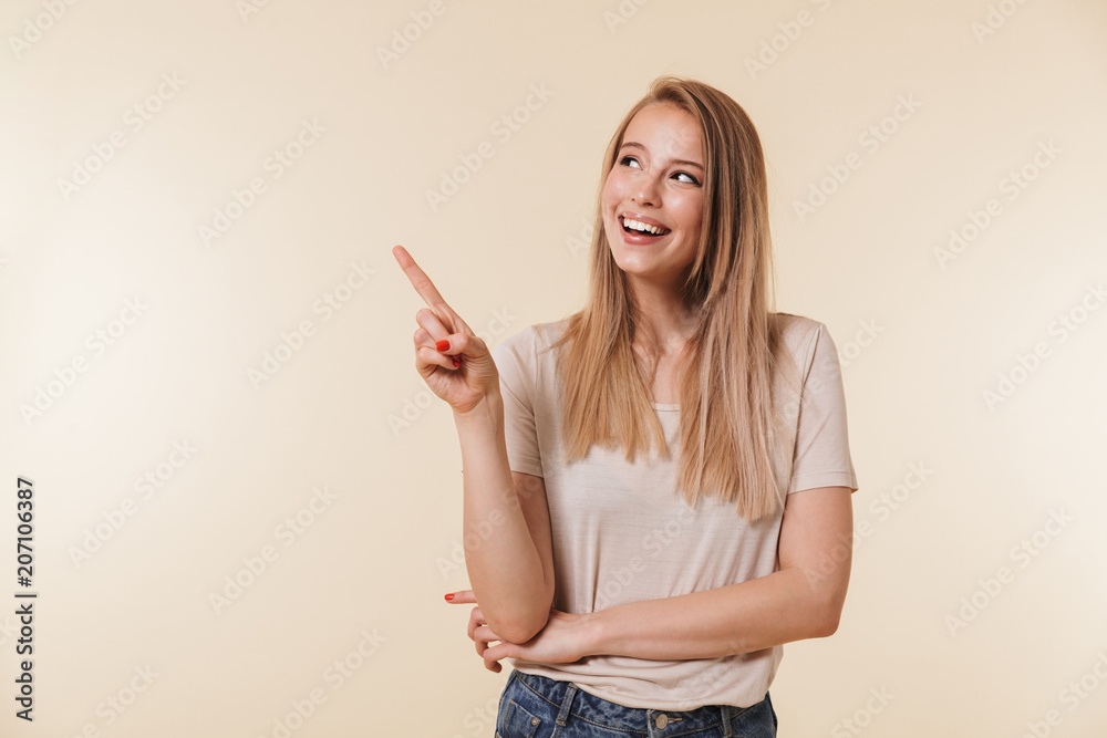 Portrait of a happy casual girl pointing finger away Portrait of a happy casual girl pointing finger away