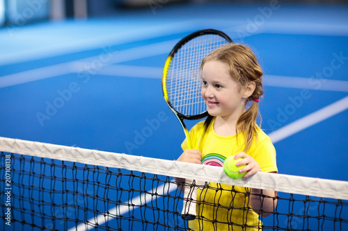 Child playing tennis on indoor court © famveldman