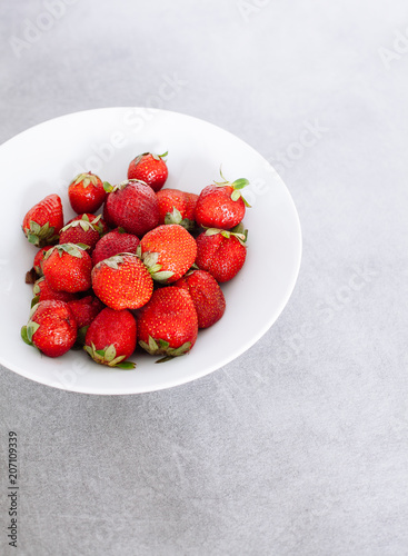 Top of view fresh strawberry in white plate in kitchen