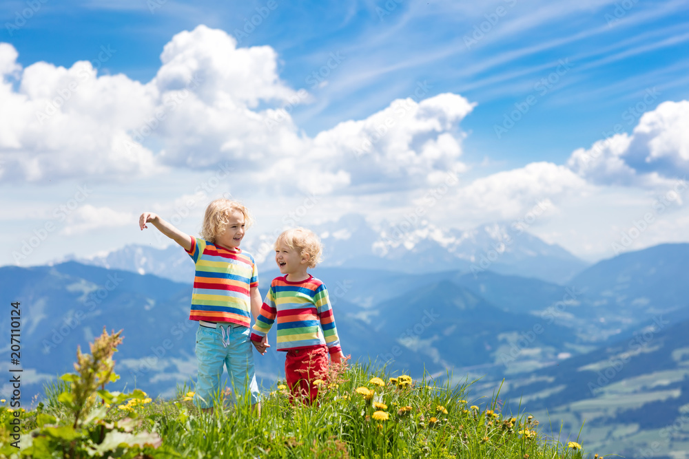 Fototapeta premium Children hiking in Alps mountains. Kids outdoor.