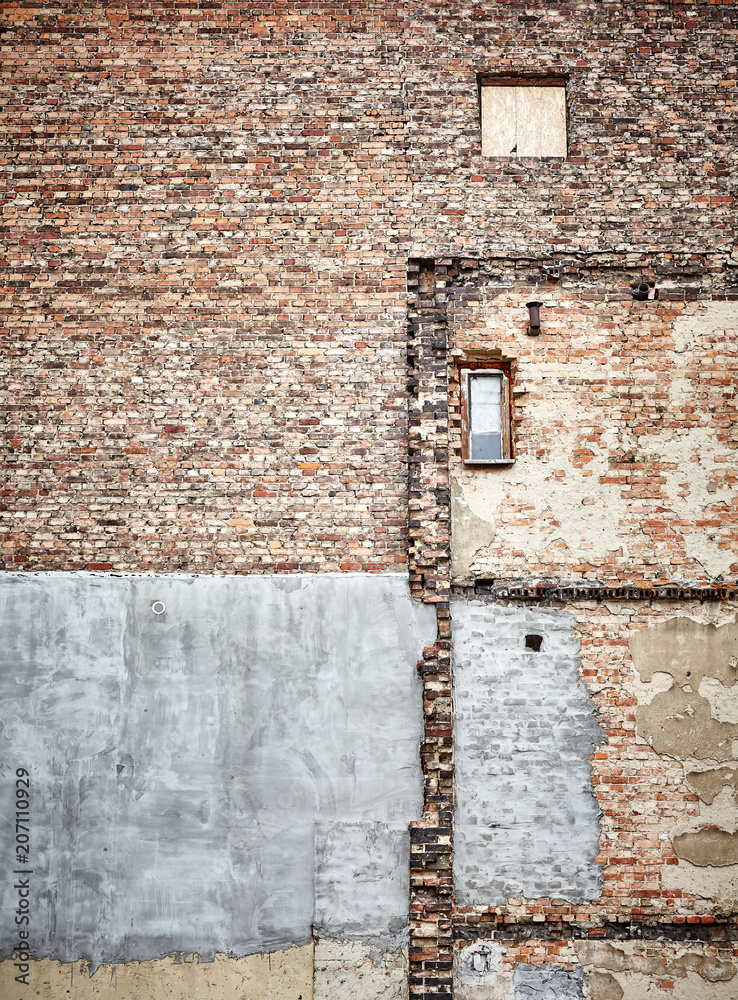 Demolished old brick building wall, grunge background.