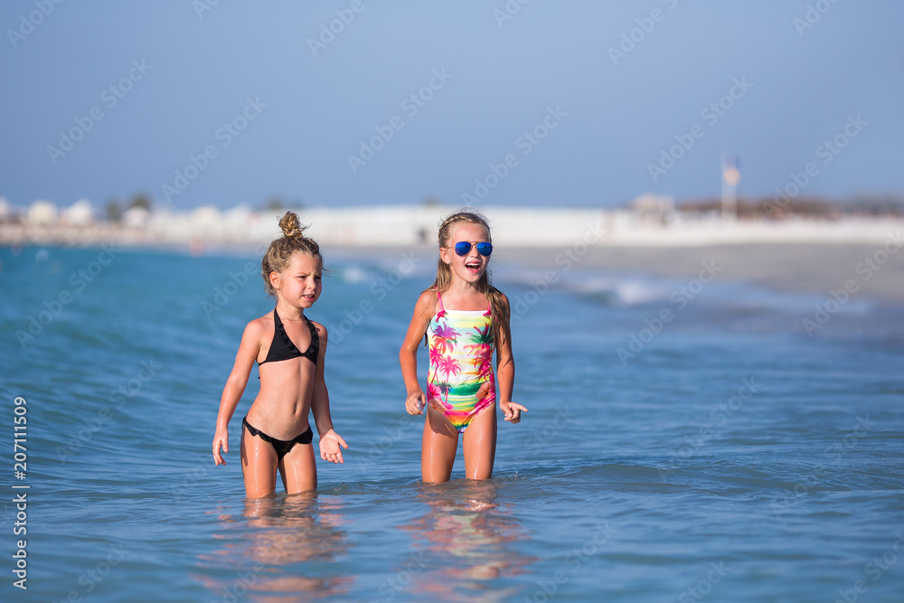 Cute happy children playing in the sea.