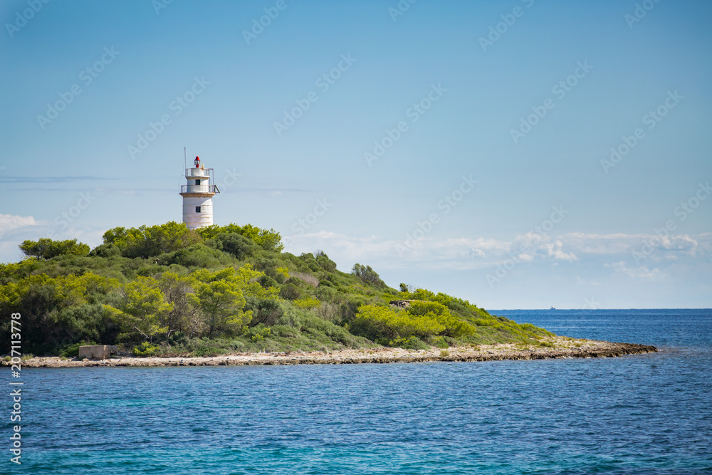 Lighthouse on the small island in the sea. Mallorca, Spain