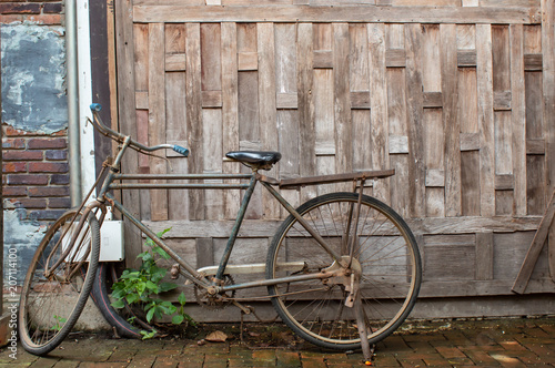 Old bicycle in front wall wood.