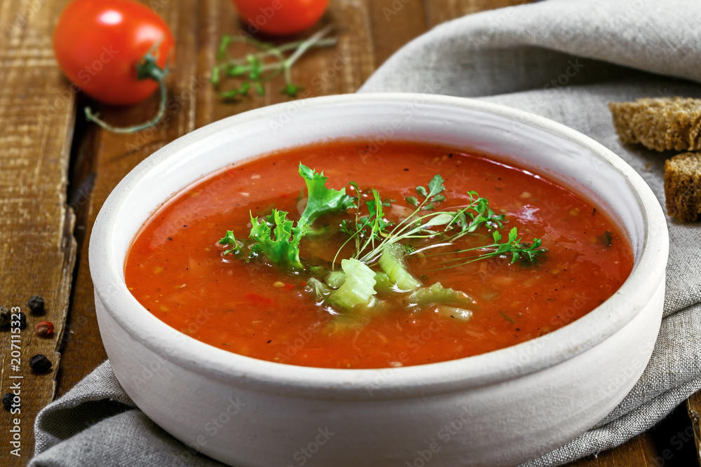 Gazpacho in a bowl, ingredients and bread. Classic Spanish cuisine vegetarian soup. Gazpacho in a bowl, ingredients and bread. Classic Spanish cuisine vegetarian soup.