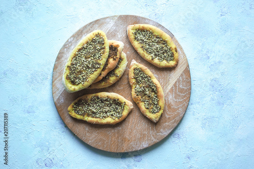 Scones with Zatar. Manakish Arabic on a wooden tray. Arabic cuisine. photo