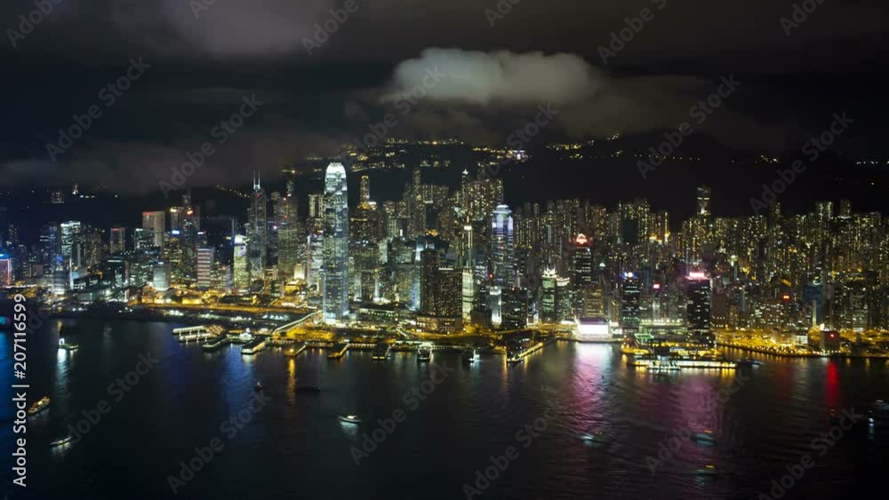 Aerial view over Hong Kong Island looking towards Victoria Peak showing the busy Victoria Harbour and Financial District of Central, Hong Kong, China, T/lapse Aerial view over Hong Kong Island looking towards Victoria Peak showing the busy Victoria Harbour and Financial District of Central, Hong Kong, China, T/lapse