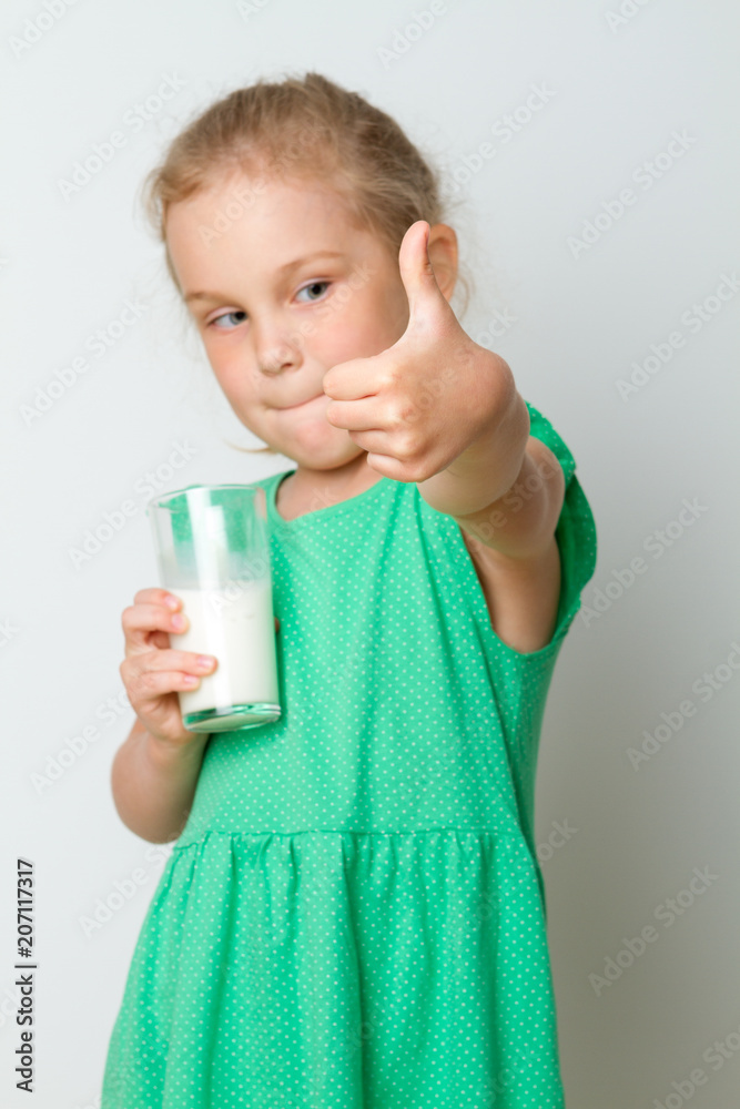 Cute girl holding glass of milk Cute girl holding glass of milk