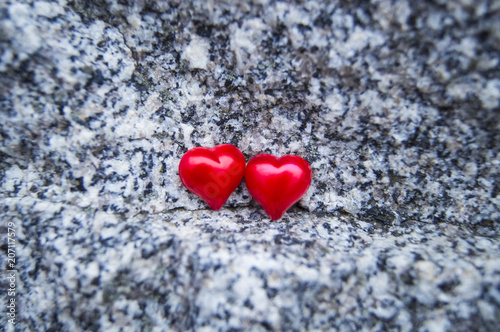 two red hearts on a beautiful stone background