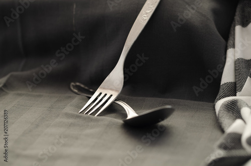 On napkin texture with fork spoon top view,dark style