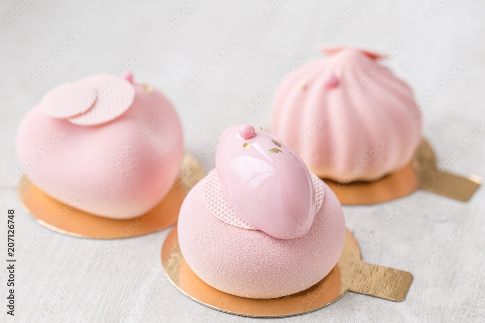 Pink mousse-cake. French dessert and flowers eucalyptus on a white background. pastel colors Pink mousse-cake. French dessert and flowers eucalyptus on a white background. pastel colors