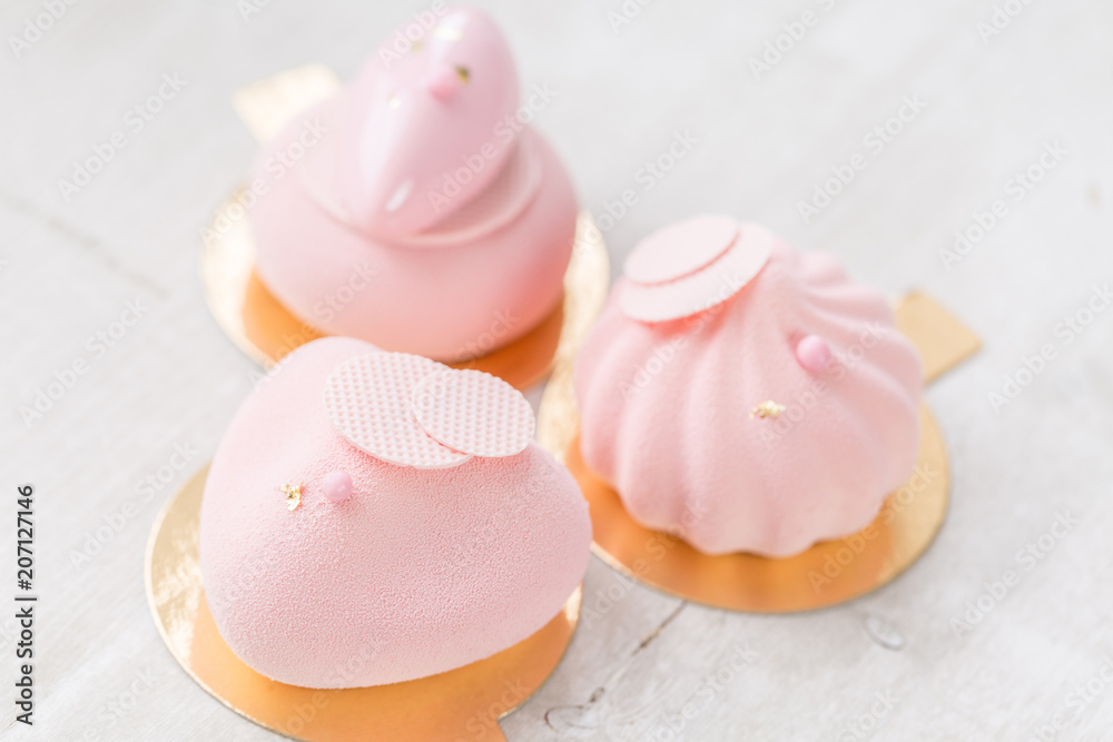 Pink mousse-cake. French dessert and flowers eucalyptus on a white background. pastel colors Pink mousse-cake. French dessert and flowers eucalyptus on a white background. pastel colors