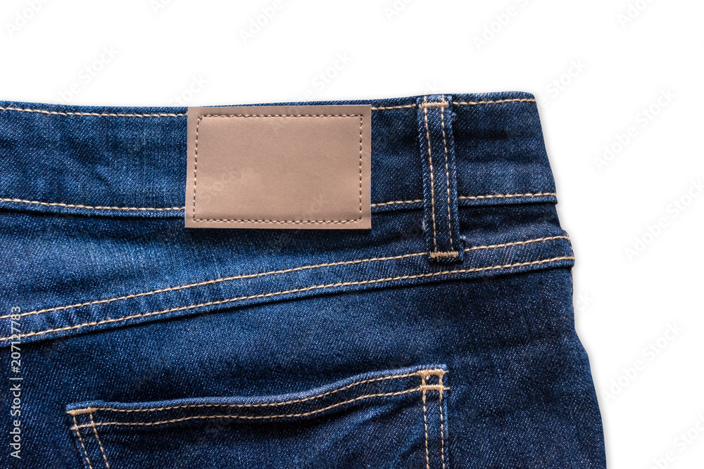 Back of blue jeans with leather jeans label sewed on blue jeans. Isolated on white background with clipping path.