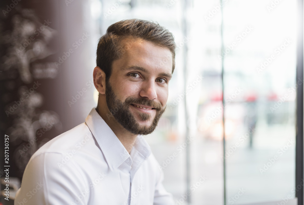 Portrait of smiling young businessman at the window Portrait of smiling young businessman at the window