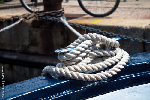 The boat moored to the pier with a beautiful white rope