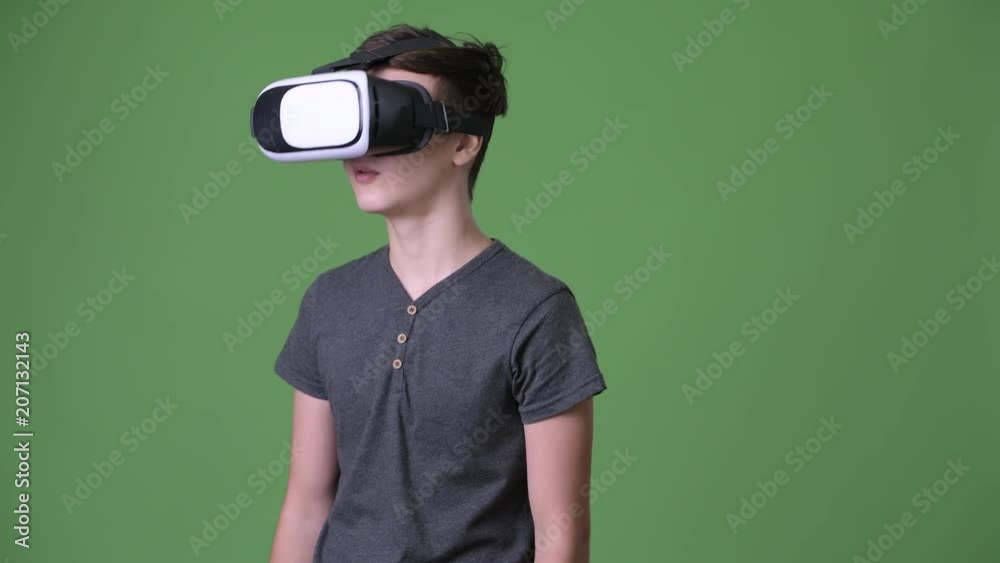 Young handsome Iranian teenage boy against green background Young handsome Iranian teenage boy against green background