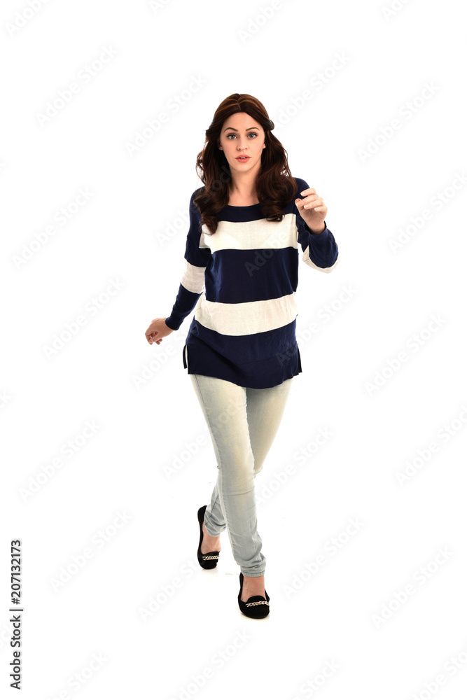 full length portrait of girl wearing striped blue and white jumper and jeans. standing pose on white studio background full length portrait of girl wearing striped blue and white jumper and jeans. standing pose on white studio background