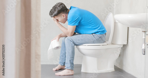 man feel pain with constipation photo