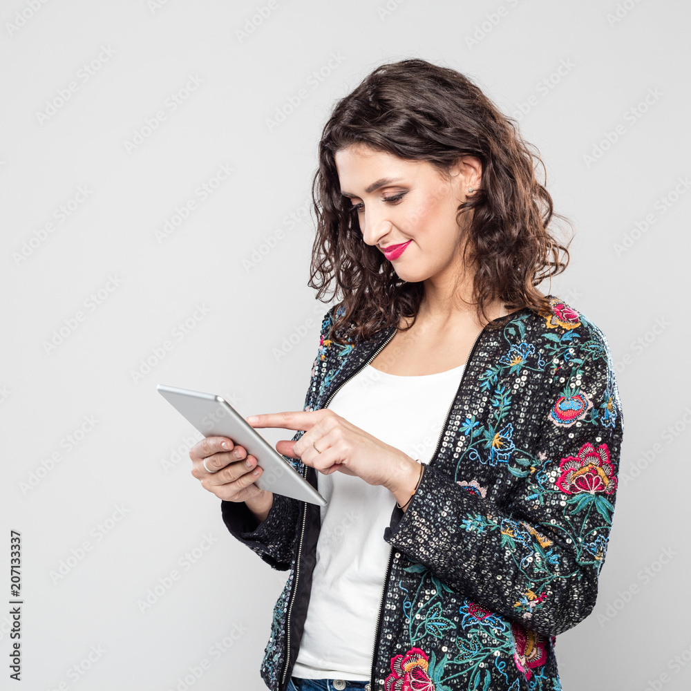 Portrait of smiling young woman using a digital tablet Portrait of smiling young woman using a digital tablet