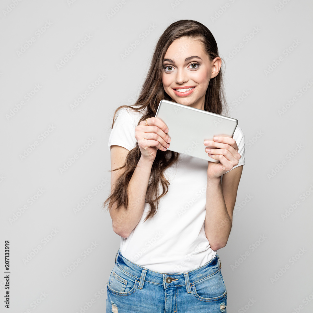 Portrait of cute, happy young woman holding digital tablet Portrait of cute, happy young woman holding digital tablet