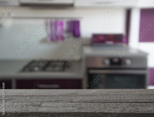 Blurred background. Modern kitchen with tabletop and space for you.