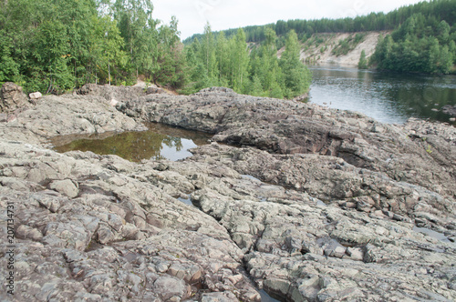 rocky riverbed and ancient extinct volcano and geyser in Karelia
