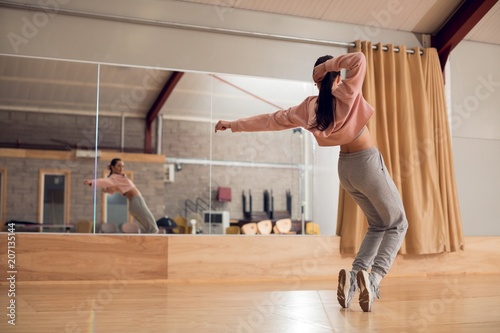 Young woman dancing in studio photo
