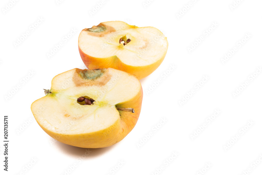 aufgeschnittener Apfel mit brauner Stelle und grünem Schimmelpilz, weißer Hintergrund