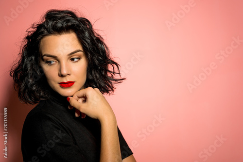 Young women on pink background