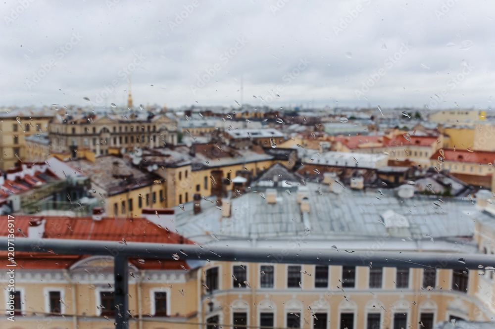 Beautiful aerial cityscape. Rainy day at Saint-Petersburg, Russia. Rooftop view on old buildings and St Isaac Cathedral. Russia tourism to St Petersburg roof. City landscape