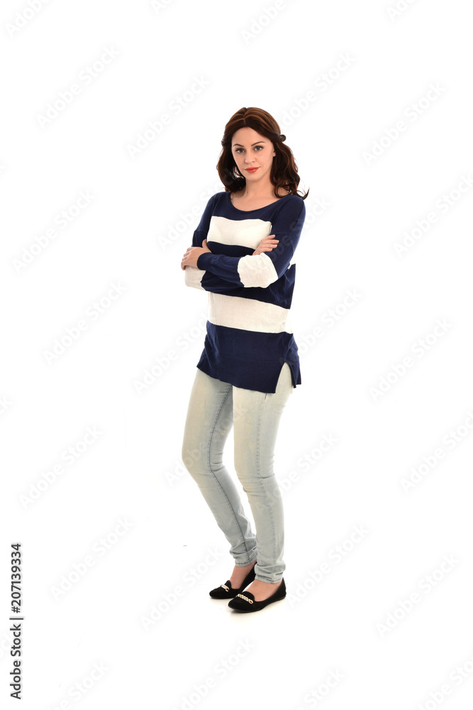 full length portrait of girl wearing striped blue and white jumper and jeans. standing pose on white studio background full length portrait of girl wearing striped blue and white jumper and jeans. standing pose on white studio background