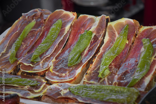 Grilled bread with jamon iberico with baked green pepper. Selective focus photo