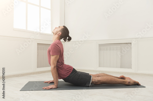 Man practicing yoga at gym